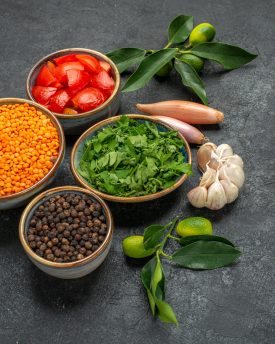 side-close-up-view-spices-lentil-spices-herbs-onions-tomatoes-garlic-citrus-fruits-with-leaves